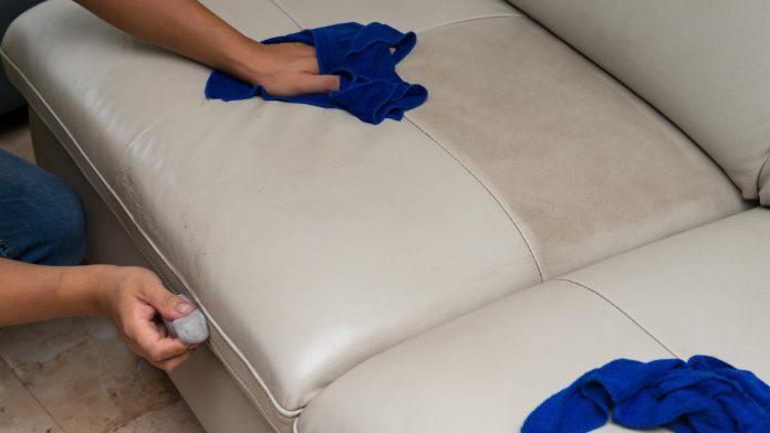 Cleaning,Leather,Sofa,With,Sponge,And,Towel,At,Home