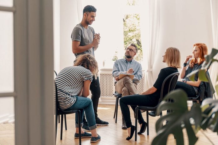 group-therapy-session-man-standing